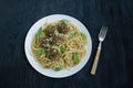 Pasta with meatballs and parsley in tomato sauce. Dark wooden background. View from above Royalty Free Stock Photo