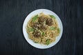 Pasta with meatballs and parsley in tomato sauce. Dark wooden background. View from above Royalty Free Stock Photo