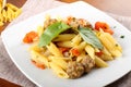 Pasta with meatballs, tomato and basil