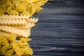 Pasta mix on wooden background Royalty Free Stock Photo