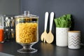 Pasta in modern kitchen glass container on table Royalty Free Stock Photo