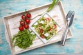 Pasta with mozarella cheese, arugula and vegetables on a wood background Royalty Free Stock Photo