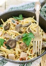 Pasta with mushrooms and meat in a creamy sauce. Spaghetti, oyster mushrooms, chicken and parsley Royalty Free Stock Photo