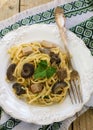 Pasta with mushrooms and meat in a creamy sauce. Spaghetti, oyster mushrooms, chicken and parsley Royalty Free Stock Photo