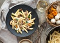 Pasta with mushrooms on rustic tabletop.