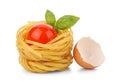 Pasta nest with tomato and basil next to eggshell Royalty Free Stock Photo