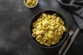 Pasta Orecchiette with sauce pesto on black background.