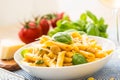 Pasta penne with chicken pieces mushrooms basil parmesan cheese and white wine. Italian food in white plate on kitchen Royalty Free Stock Photo