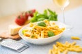 Pasta penne with chicken pieces mushrooms basil parmesan cheese and white wine. Italian food in white plate on kitchen Royalty Free Stock Photo