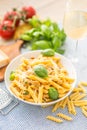 Pasta penne with chicken pieces mushrooms basil parmesan cheese and white wine. Italian food in white plate on kitchen Royalty Free Stock Photo