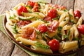 Pasta penne with fried ham, cherry tomatoes, zucchini and cheese Royalty Free Stock Photo