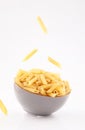 Pasta penne in gray bowl on white background Royalty Free Stock Photo