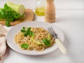 Pasta with pesto sauce, basil and zucchini.