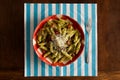 Pasta with pesto sauce, parmesan on gingham plate, turquoise nap Royalty Free Stock Photo