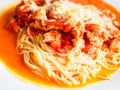 Pasta with pieces of chicken and tomatoes on a white plate. Spaghetti with tomato sauce and pieces of chicken or turkey. Italian Royalty Free Stock Photo