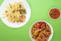 Pasta on a plate with vegetables on a colored background. Mediterranean food on with vegetable salad and sauce. healthy food top Royalty Free Stock Photo