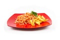 Pasta and potatoes on a red plate on white background Royalty Free Stock Photo