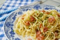 Pasta primavera with grilled shrimps on blue plate close up Royalty Free Stock Photo