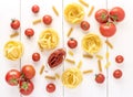 Pasta Products with Tomato Raw Pasta Fusili Fettuccine Ingredients Italian Food White Background Top View Flat lay