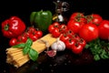 Pasta raw on black with tomatoes,olive oil,garlic verti Royalty Free Stock Photo