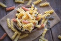 Pasta raw macaroni on wooden bowl background, close up raw macaroni spiral pasta uncooked delicious whole grain fusilli pasta for Royalty Free Stock Photo