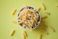 Pasta raw macaroni on yellow background, close up raw macaroni spiral pasta uncooked delicious whole grain fusilli pasta for Royalty Free Stock Photo