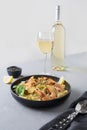 Pasta reginelle with seafood, shrimps, mussels in black plate on gray stone table, close up. Traditional dish in Italian Royalty Free Stock Photo