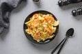 Pasta reginette with seafood, shrimps, mussels black plate on grey table. Traditional dish in Italian Royalty Free Stock Photo