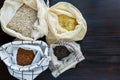 Pasta, rice, buckwheat and groats in reusable cotton bags on the black wooden table in the kitchen. Zero Waste concept. Top view. Royalty Free Stock Photo