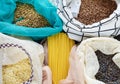 Pasta, rice, buckwheat and groats in reusable cotton bags on the black wooden table in the kitchen. Zero Waste concept. Top view. Royalty Free Stock Photo