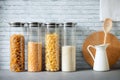 Pasta, rice, grains, beans in transparent glass jars on the kitchen countertop, zero waste kitchen, eco food storage, kitchen orde Royalty Free Stock Photo
