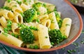 Pasta rigatoni with broccoli and green peas. Vegan menu