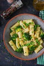 Pasta rigatoni with broccoli and green peas. Vegan menu.