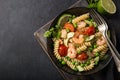 Pasta salad with avocado, shrimps, tomato and grean peas