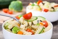 Pasta salad in a bowl on rustic wooden background Royalty Free Stock Photo