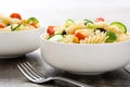 Pasta salad in a bowl on rustic wooden table Royalty Free Stock Photo