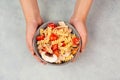 Pasta salad in a bowl, sliced mushroom, tomato, red pepper pieces and tuna, healthy food with vegetables, fresh nutrition