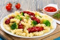 Pasta salad with broccoli and grilled sausages, close-up Royalty Free Stock Photo