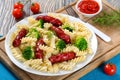 Pasta salad with broccoli and grilled sausages, close-up Royalty Free Stock Photo