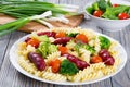 Pasta salad with broccoli, grilled sausages and tomatoes Royalty Free Stock Photo