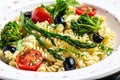 Pasta salad. Fusilli Pasta with tomato, broccoli, black olives, and asparagus. Food recipe background. Close up