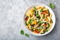 Pasta salad with grilled vegetables zucchini, eggplant, bell pepper ant tomato and feta cheese