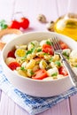 Pasta salad with quail eggs, mozzarella, cherry tomatoes and capers in bowl on purple wooden background Royalty Free Stock Photo