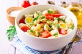 Pasta salad with quail eggs, mozzarella, cherry tomatoes and capers in bowl on purple wooden background Royalty Free Stock Photo