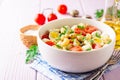 Pasta salad with quail eggs, mozzarella, cherry tomatoes and capers in bowl on purple wooden background Royalty Free Stock Photo