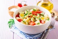 Pasta salad with quail eggs, mozzarella, cherry tomatoes and capers in bowl on purple wooden background Royalty Free Stock Photo