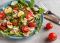 Pasta salad with quail eggs, tomatoes, rucola, mozzarella and basil