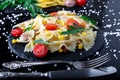 Pasta salad in slate plate with tomatoes cherry, tuna, corn and arugula. ingredients. Italian food. Royalty Free Stock Photo