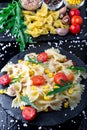 Pasta salad in slate plate with tomatoes cherry, tuna, corn and arugula. Top view. ingredients. Italian food. Royalty Free Stock Photo