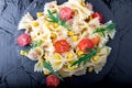 Pasta salad in slate plate with tomatoes cherry, tuna, corn and arugula. Top view. ingredients. Italian food. Royalty Free Stock Photo